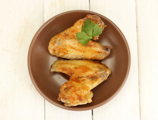 roasted chicken wings with parsley in the plate