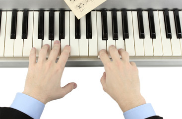 hands of man playing piano