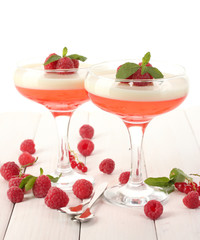 fruit jelly with berries in glasses on wooden table
