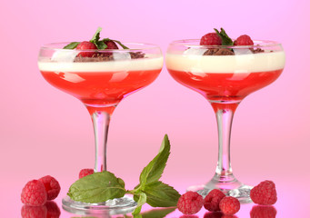 fruit jelly with berries in glasses on pink background
