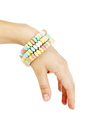 Color candies on hand isolated on white