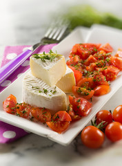 tomino cheese with pachino tomatoes salad,selective focus