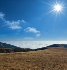 hills dense clouds and sparkle sun
