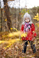 Adorable girl having fun on an autumn day