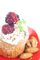 muffin with whipped cream,mint, raspberries, blackberries and nu