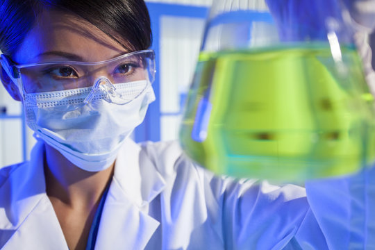 Chinese Female Woman Scientist With Green Flask In Laboratory