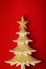 golden christmas tree on red paper background