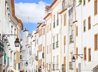 Fototapeta na wymiar White facades old urban street in Evora. Alentejo, Portugal
