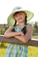 Dark-haired girl in a wicker hat