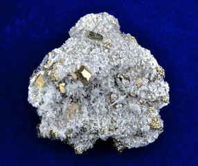 Pyrite with white quartz and calcite white on blue background