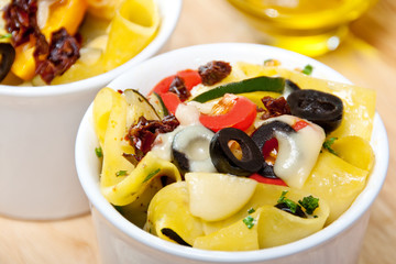 Pappardelle pasta with cherry tomatoes, olives and zucchini