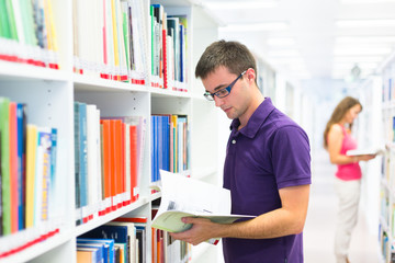 Two college students in library (color toned image; shallow DOF)