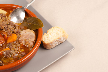Traditional Spanish lentils served in a clay pot