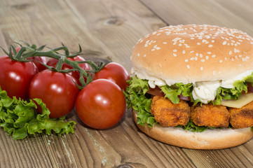 Fish Burger with ingredients on wood
