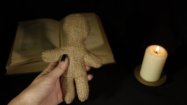 Witch voodoo doll with a pin pierces