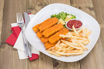Portion of Fish Fingers on wooden background