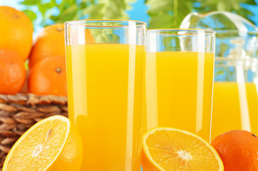 Composition with two glasses of orange juice and fruits