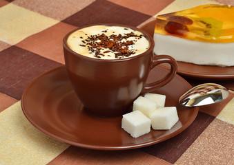 The cup of coffee and the pana cotta on the plate