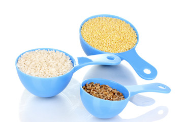 Measuring spoons with grain isolated on white