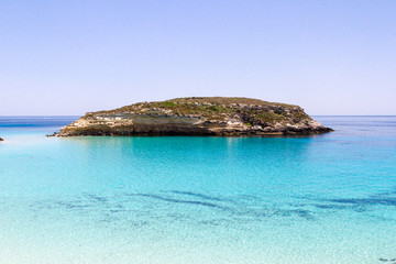 Pure crystalline water surface around an island (Lampedusa) - obrazy, fototapety, plakaty