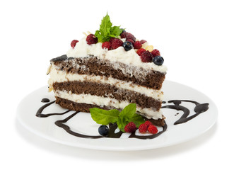 Piece of chocolate cake with chocolate glaze, whipped cream, wil