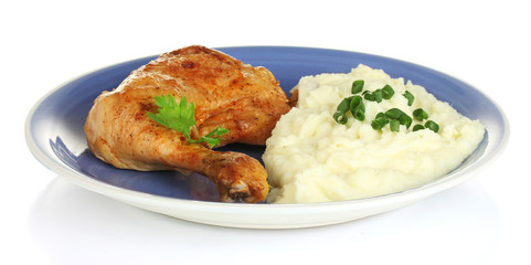 roasted chicken leg with mashed potato in the plate isolated
