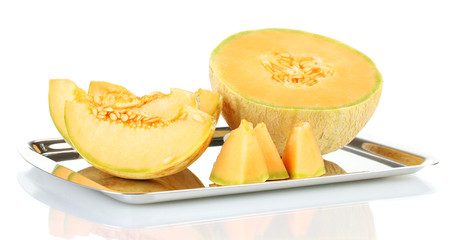 Cut melon on metal tray isolated on white