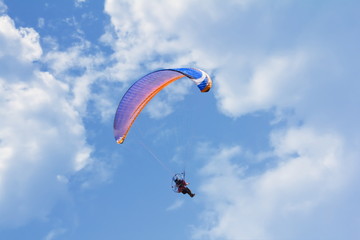 glider in the sky with clouds