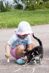 Girl playing and painting with cat