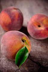Fresh peaches on wooden table