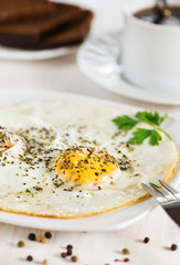 Fried eggs and cup of coffee