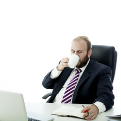 beard business man drink coffee while working on computer