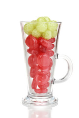 Color candies in glass isolated on white