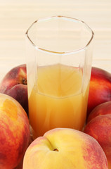 Ripe peaches and juice close-up on wooden table