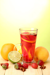 Refreshing sangria in glass with fruits,