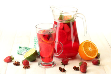 sangria in jar and glass with fruits,