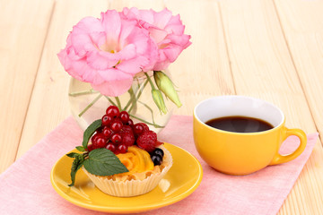 Dulcet cake with fruit and berries on wooden table