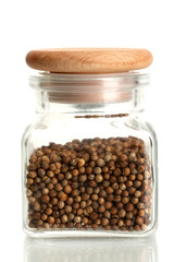 Jar of coriander seeds isolated on white