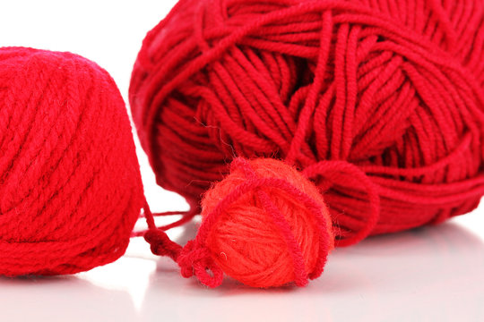 Red knittings yarns isolated on white