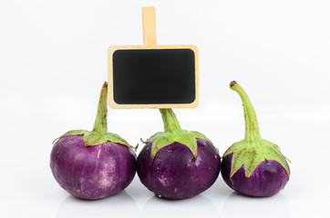 Round eggplant with blackboard isolated on white.