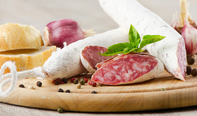 Salami sliced on wooden table
