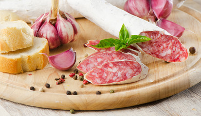 Salami sliced on wooden table