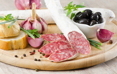 Salami sliced on wooden table