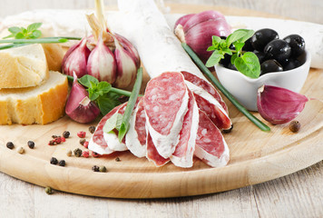 Salami sliced on wooden table