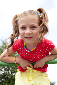 Smiling girl plays on the playground