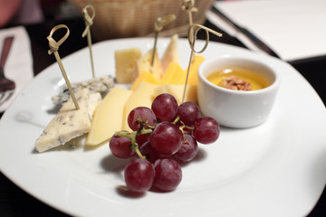 Various cheeses and grapes