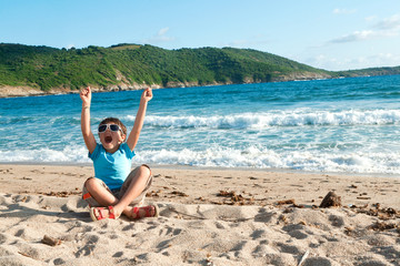 child rejoices at the beach