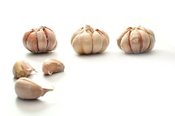 Garlic bulbs in three positions, isolated on white
