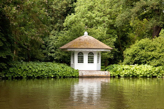 little house in rich garden on the embankment of the river