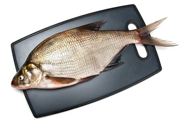 Fresh fish bream on a cutting board on a white background